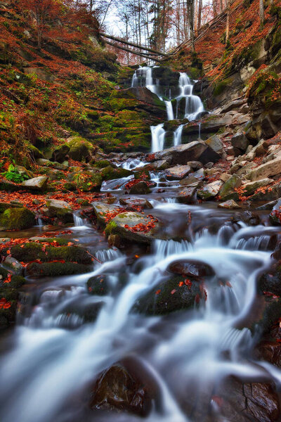 picturesque waterfall in the autumn forest. Nature of Ukraine