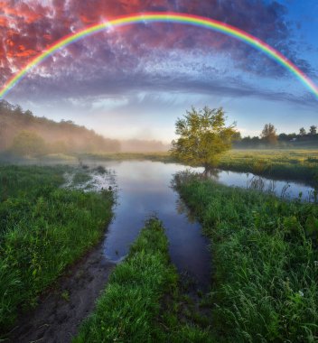 Landscape with a Rainbow on the River in Spring. colorful morning. nature of Ukraine