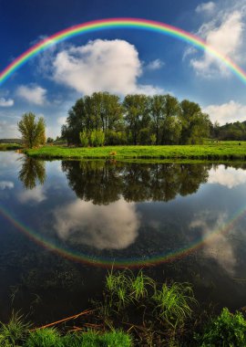 Landscape with a Rainbow on the River in Spring. colorful morning. nature of Ukraine