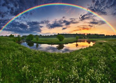 Landscape with a Rainbow on the River in Spring. colorful morning. nature of Ukraine