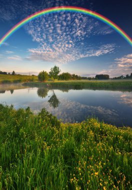 Landscape with a Rainbow on the River in Spring. colorful morning. nature of Ukraine