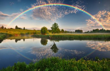 Landscape with a Rainbow on the River in Spring. colorful morning. nature of Ukraine