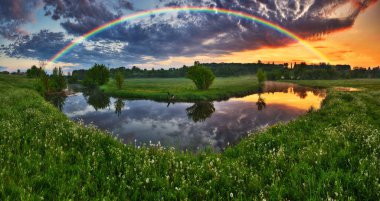 Landscape with a Rainbow on the River in Spring. colorful morning. nature of Ukraine