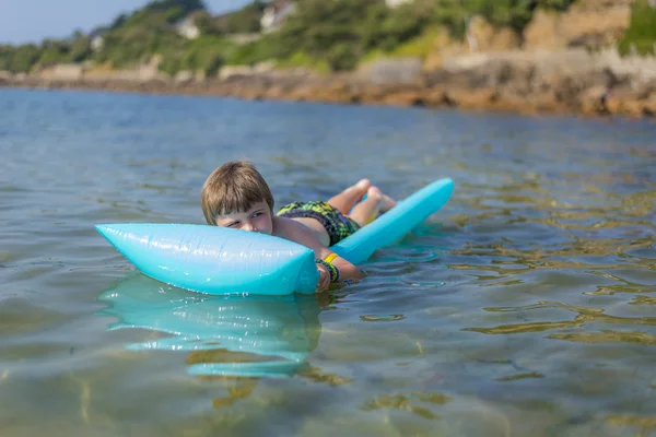 Boy on inflatable mattrass — Stock Photo, Image