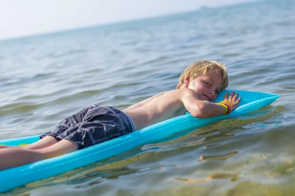 Boy on inflatable mattrass — Stock Photo, Image