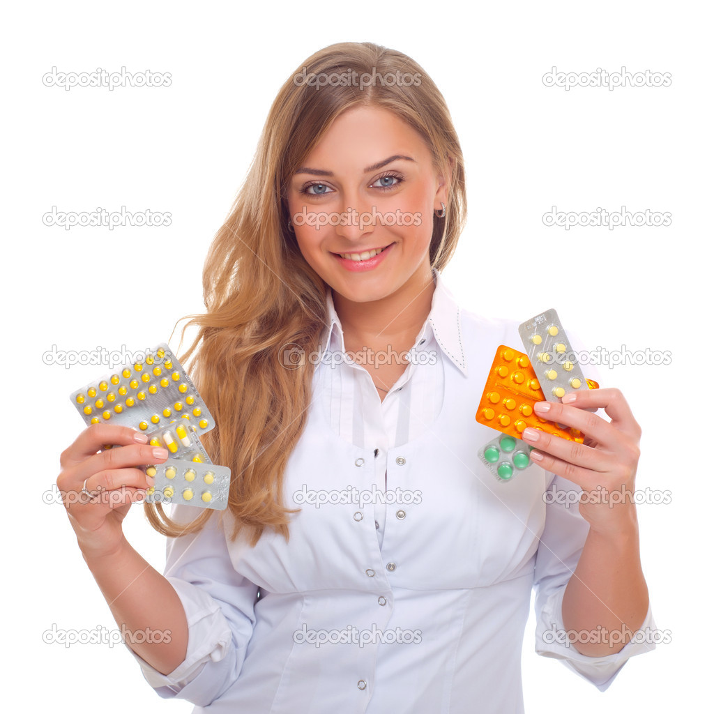 portrait of a pretty female doctor with pills in hand