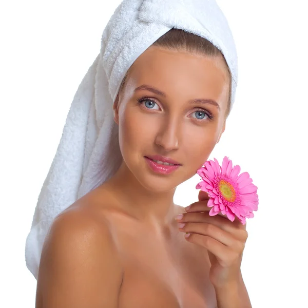 Hermosa joven sonriente mujer con una toalla en la cabeza y una flor —  Fotos de Stock