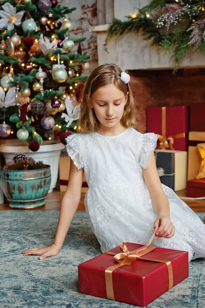 Dziewczyna Białej Sukience Czerwonym Pudełkiem Pokoju Urządzonym Boże Narodzenie Siedząc — Zdjęcie stockowe