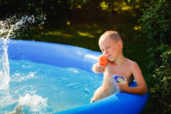 Boy Plays Water Pistol Inflatable Pool Garden Sunny Summer Day — Fotografia de Stock