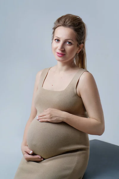 Close Portrait Pregnant Woman Beige Dress Hugging Her Stomach Both Stock Picture