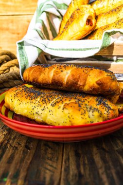 Kırsal bir masada puf böreği içinde sosis. Tatlı sosisli sandviç.