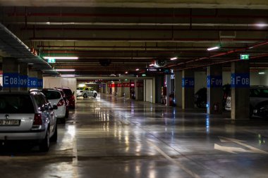 Otoparkın içinde park edilmiş birkaç araba var. Bükreş, Romanya 'daki yeraltı otoparkı, 2021