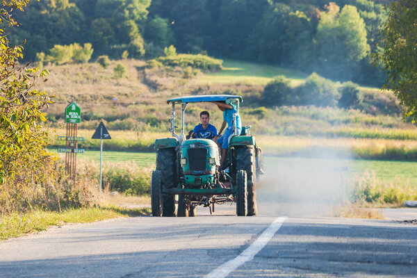 Agricultural tractor on road in Viscri, Romania, 2021