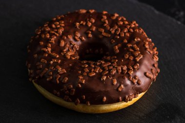 Çikolata kaplı çörek ve çikolata parçacıkları izole edilmiş. Lezzetli çörekleri yakın çekin..