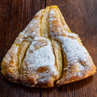 Tahtaya şeker tozu sürülmüş taze pişmiş elmalı turta. Ev yapımı elmalı pasta..