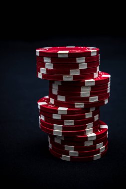 Siyah arkaplanda poker çipleri yığını