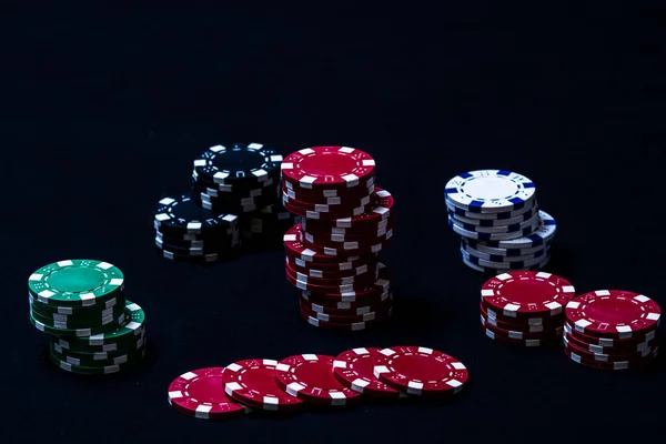 Stack of poker chips on black background - Stock Image - Everypixel
