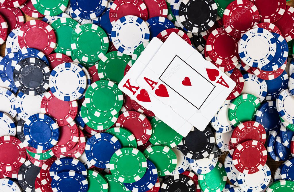 Poker hand over poker chips background. Casino concept for business, risk, chance, good luck or gambling