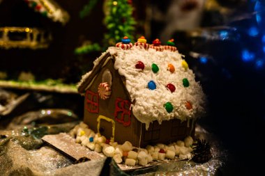 Arka planda bulanık bir Noel süsü var. Şekerli zencefilli ev.