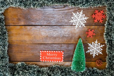 Tahtada Noel çelengi ve süslemeleri olan bir Noel kompozisyonu. Sınır ve kopyalama alanı ile yaratıcı kompozisyon, üst görünüm, düz yatay. Noel çerçevesi.