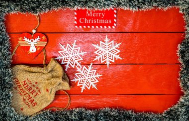 Noel çelengi ve süslemeleri olan kırmızı tahta üzerinde Noel kompozisyonu. Sınır ve kopyalama alanı ile yaratıcı kompozisyon, üst görünüm, düz yatay. Noel çerçevesi.