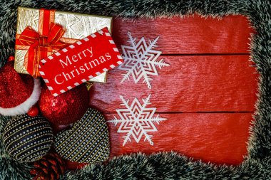Noel çelengi ve süslemeleri olan kırmızı tahta üzerinde Noel kompozisyonu. Sınır ve kopyalama alanı ile yaratıcı kompozisyon, üst görünüm, düz yatay. Noel çerçevesi.