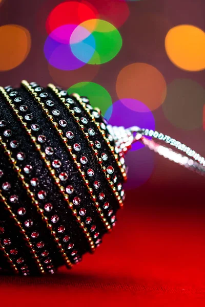Black Shiny Christmas Ball Bauble Christmas Composition Blurred Lights Background — Stock Photo, Image