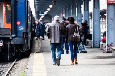 Bükreş 'teki Bükreş Kuzey Tren İstasyonu' nun (Gara de Nord Bükreş) tren peronunda tren bekleyen gezginler ve banliyö sakinleri, 2022