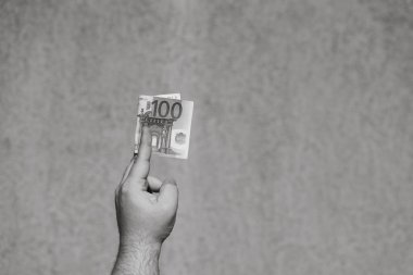 El ele tutuşup para göstermek ya da para vermek. Dünya para kavramı, 100 EURO banknotları izole edilmiş para birimi. Zengin iş adamları kavramı, para biriktirmek ya da harcamak.