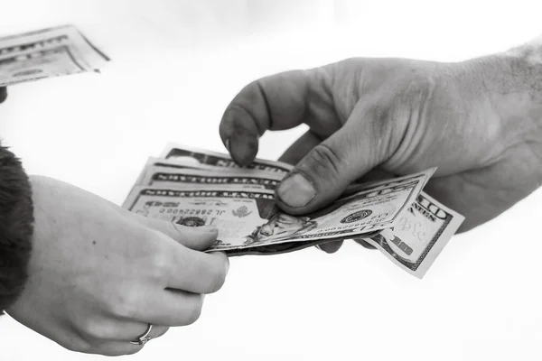 Hand giving money isolated, hard worked hand taking dollars money. Currency transfer on white background.