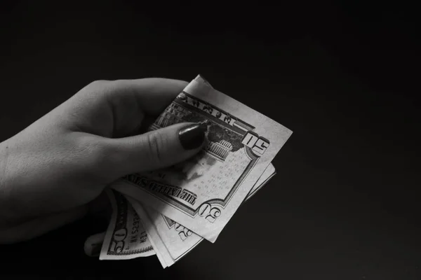 Woman counting money, counting dollars close up