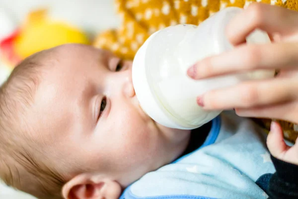 Bottle feeding newborn baby. Maternity and healthy lifestyle concept