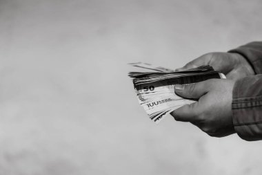 Man hand giving money like a bribe or tips. Holding EURO banknotes on a blurred background, EURO currency