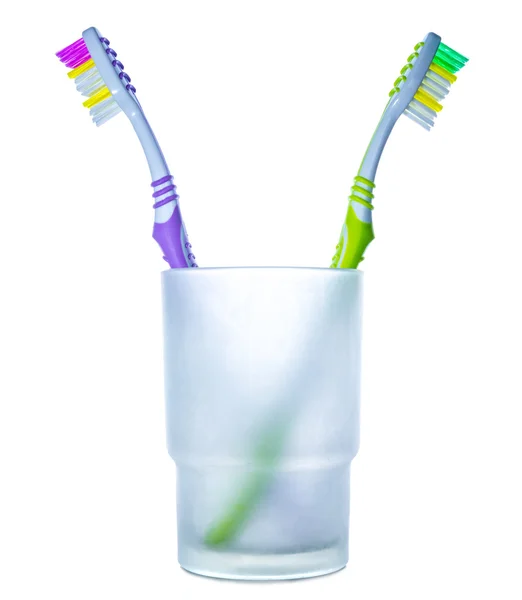 Disagreement: two colorful toothbrushes in glass — Stock Photo, Image