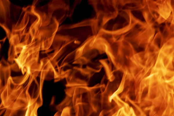 Abstrakte Flamme, Feuerflammenstruktur, Hintergrund. Feuerzungen auf dunklem Hintergrund. Stockbild