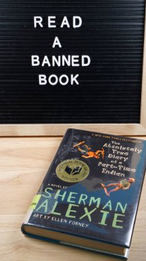 Reminder to read a banned book, along with a copy of Sherman Alexie's The Absolutely True Diary of a Part-Time Indian, which is often on schools' banned book lists. 