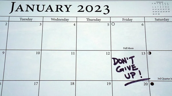 Don\'t Give Up! Message written on a calendar on the 13th of January which is Quitter\'s Day. Research has shown that people quit their resolutions for the year by the second Friday of January.