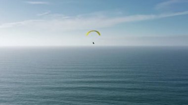 Sonsuz Atlantik Okyanusu 'nun üzerinde uçan bir paraglider görüntüsü.