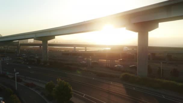 Scenic 4K aerial view busy highway with golden sunset on moving background USA — Stok Video