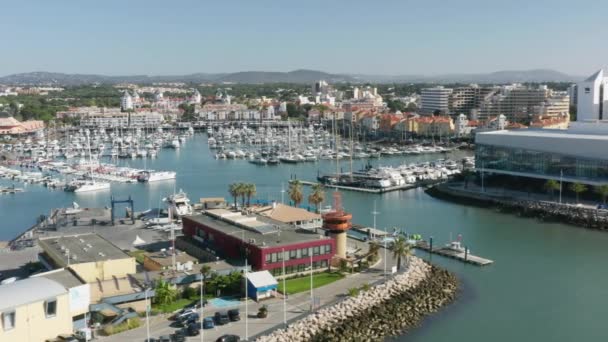 Aerial view of modern, lively marina of large leisure resort — Stock Video