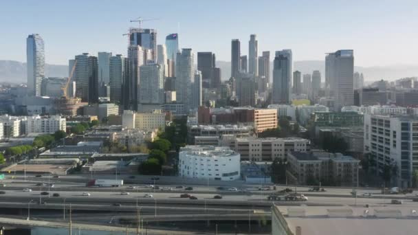 Reger Verkehr auf der Autobahn mit modernen gläsernen Wolkenkratzern, Hintergrund Los Angeles — Stockvideo