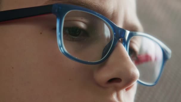 Portrait of a focused and serious boys face, wearing blue eyeglasses — Stock Video