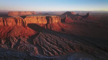 Magical sunrise light shinning on red canyon cliff wall, rocks on background