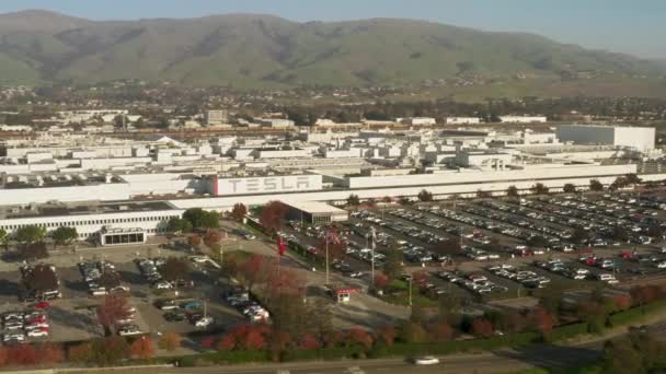 Aerial of electric car vehicles recharging at parking lot in front Tesla Factory — 비디오