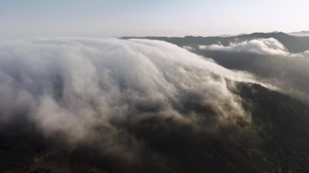 Beautiful white clouds flowing smoothly above high mountains peaks Malibu aerial — стокове відео