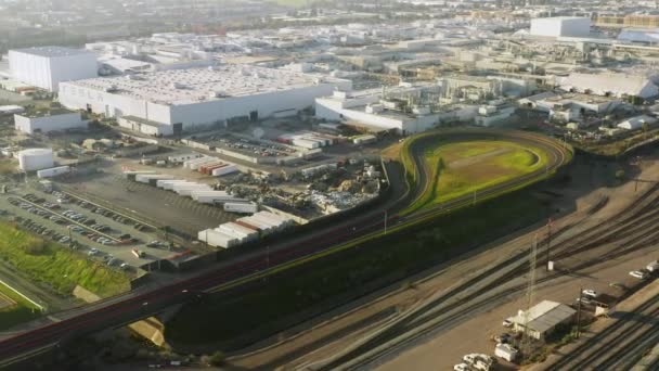 4K aerial footage of race track with brand new car driving to test, EV factory — Stok video