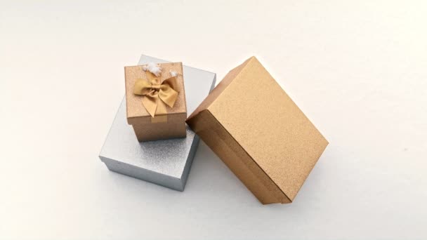 Silver and golden gift boxes with shiny satin golden ribbon with elegant bow — Stock Video