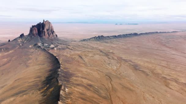 Rocky range of Shiprock, covered with yellow soil and sand as seen from above — Stock Video