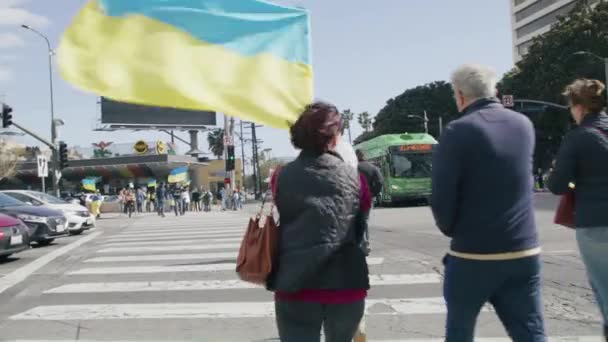 Ludzie z żółtymi niebieskimi flagami ukraińskimi protestujący przeciwko wojnie na Ukrainie — Wideo stockowe