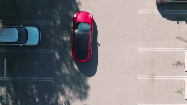 Scenic motion aerial top down shot of modern innovative self driving SUV parking — Stock Video